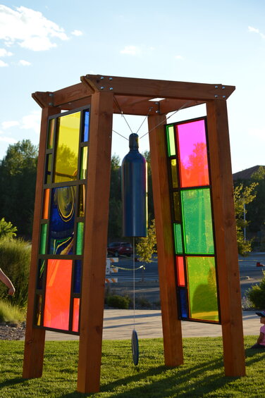 A large bell hangs in the center of the new art installation in front of the Lone Tree Arts Center on Aug. 30, 2023.